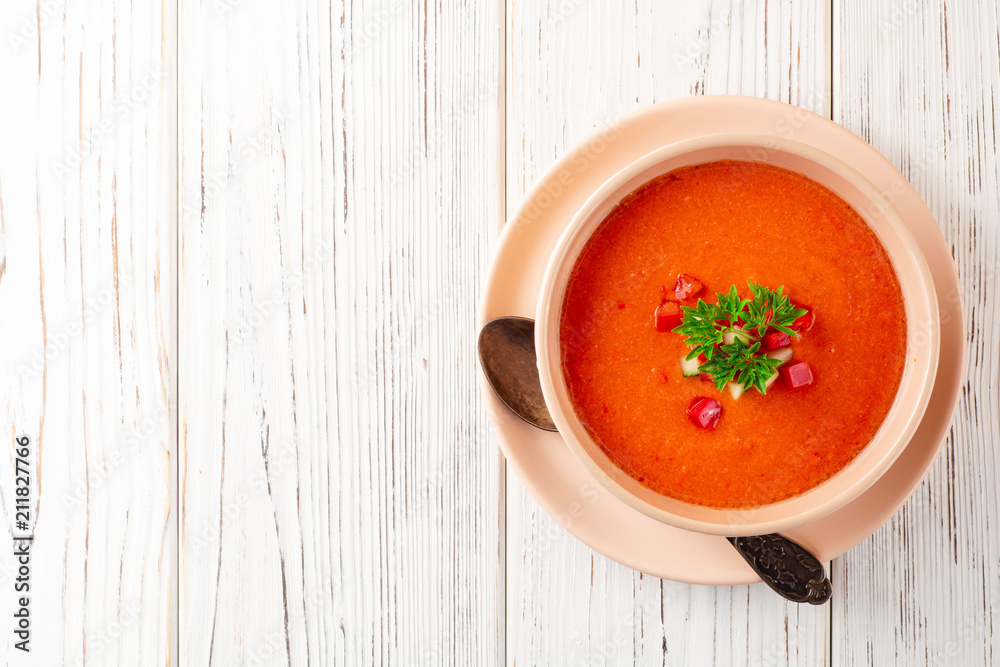 Gazpacho soup in bowl on white wooden background. Traditional spanish dish. Gazpacho soup in bowl on white wooden background. Traditional spanish dish.