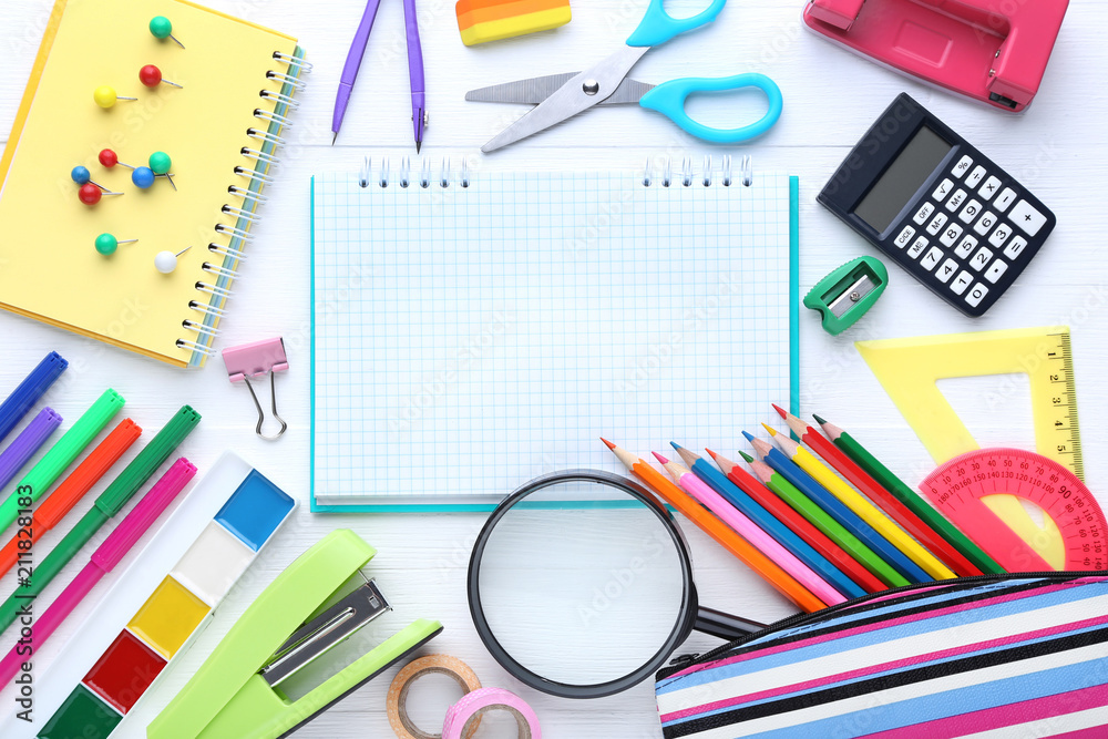 School supplies with blank sheet of paper on wooden table School supplies with blank sheet of paper on wooden table