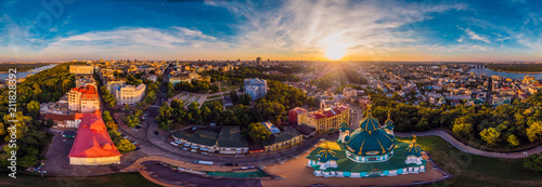 A big 360 degrees panorama of the city of Kiev on Podol at sunset. A modern metropolis in the center of Europe against the backdrop of sunset sky from a bird's eye view. Aerial view. Panorama of the