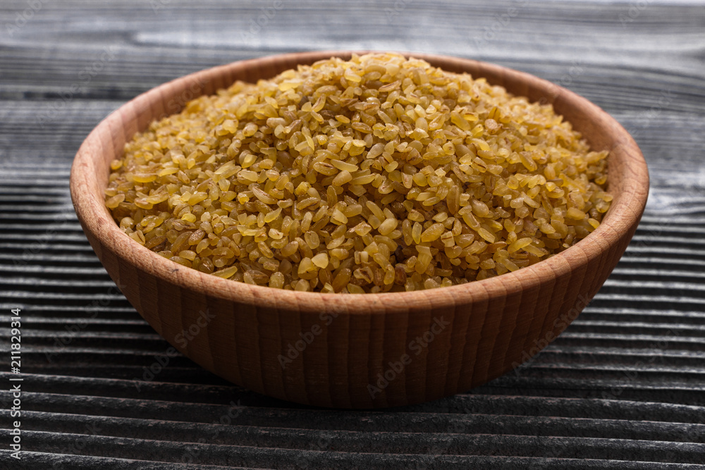 raw bulgur on a rustic wooden background raw bulgur on a rustic wooden background