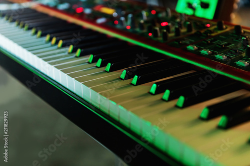 Keyboard of synthesizer closeup colored green