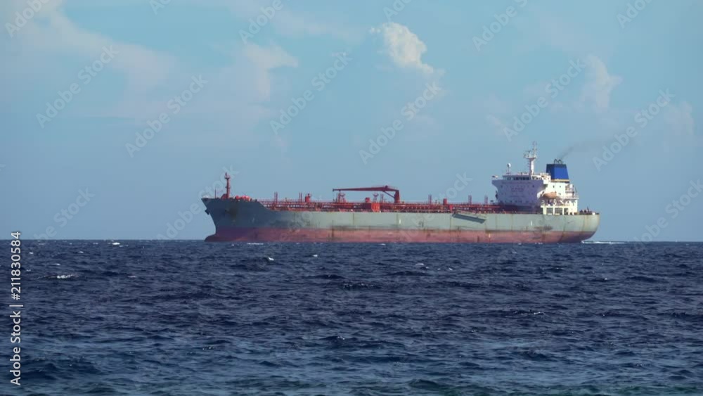 Anchored tanker or cargo ship waiting at sea Anchored tanker or cargo ship waiting at sea