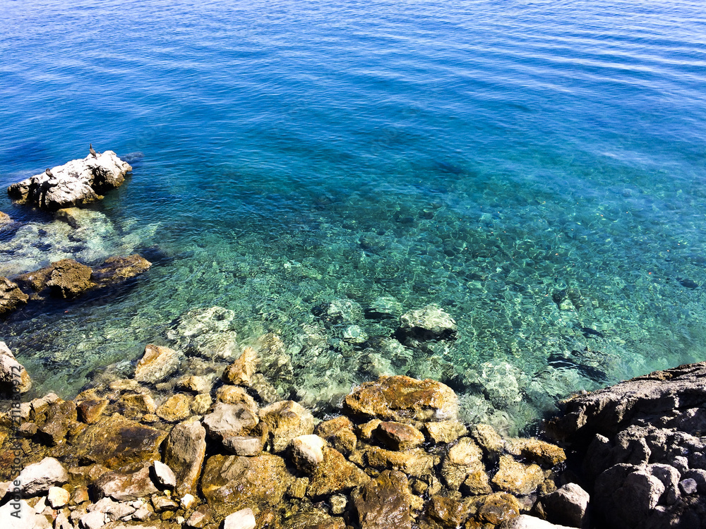 stones at the beach with clear water