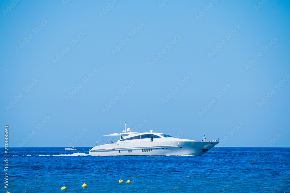 Side view of sail boat cruising in blue sea.Sailboat in the sea, active vacation in Mediterranean sea, Sea Luxury Yacht in the Mediterranean sea .Yacht in sunny summer day Side view of sail boat cruising in blue sea.Sailboat in the sea, active vacation in Mediterranean sea, Sea Luxury Yacht in the Mediterranean sea .Yacht in sunny summer day