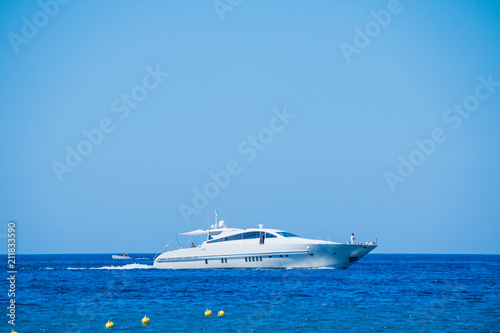 Side view of sail boat cruising in blue sea.Sailboat in the sea, active vacation in Mediterranean sea, Sea Luxury Yacht in the Mediterranean sea .Yacht in sunny summer day © Yulia
