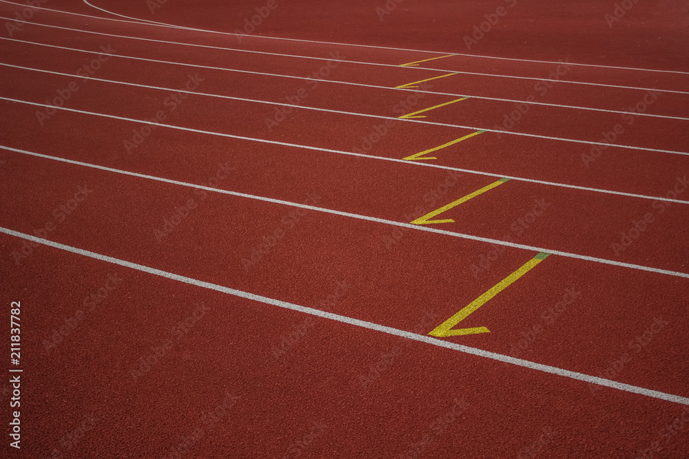 empty red running road track background texture sport concept and  white marking lanes with space for copy or text