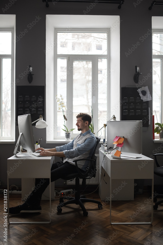 A man working in a modern design office A man working in a modern design office