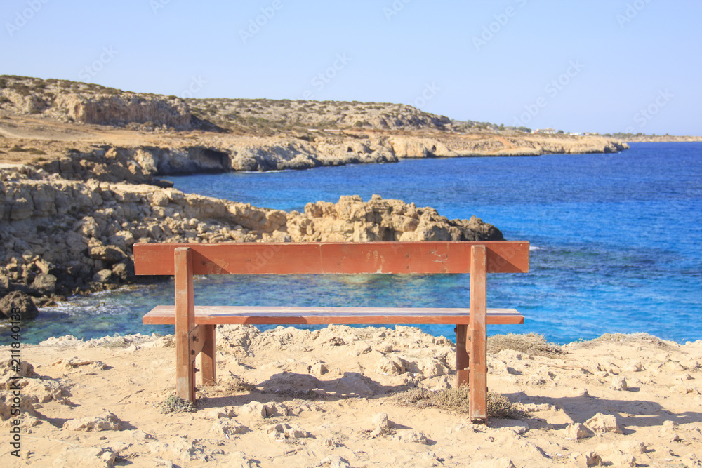 Beautiful view of a lonely bench over the sea