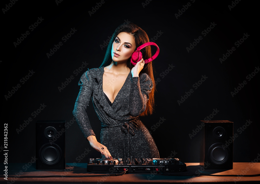 Young, beautiful and sexy dj girl playing music on a disco party in a night  club Stock Photo | Adobe Stock