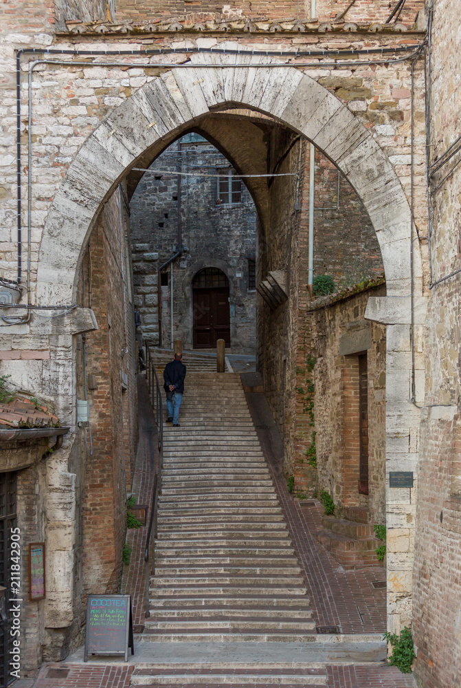 Street with arch and stairs doorway in Italy
