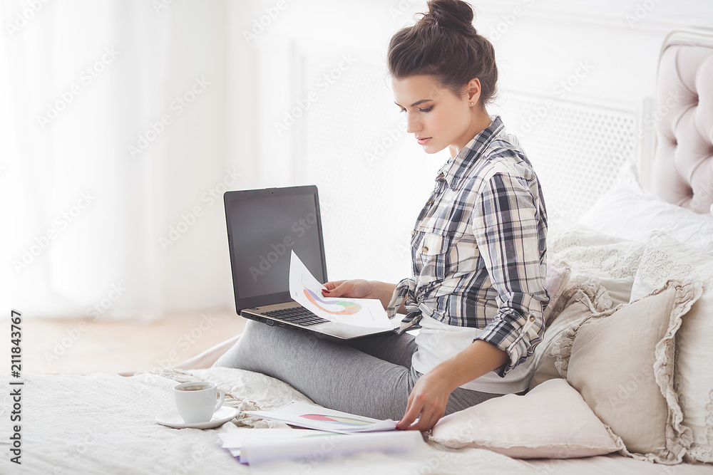 Young attractive woman working home at the laptop Young attractive woman working home at the laptop