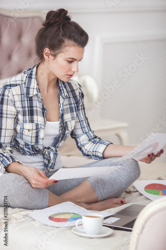 Young attractive woman working home at the laptop