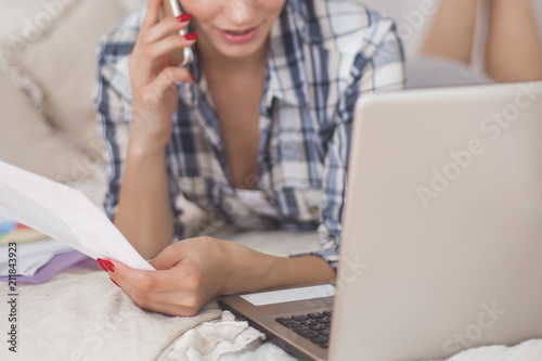 Young attractive woman working home at the laptop