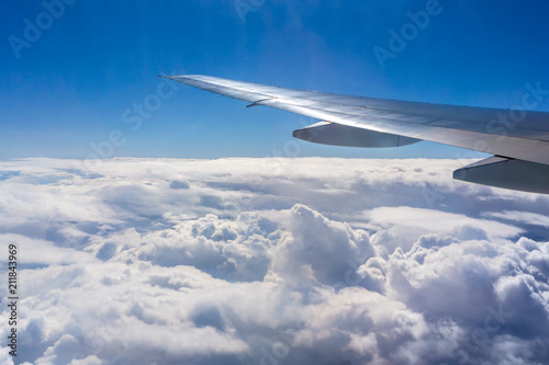 Flying above the sky. Shape of the airplane wing on a blue sky.