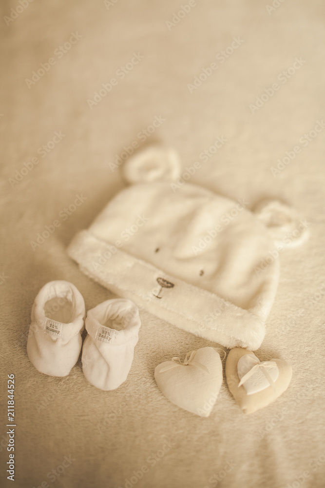 Little hand made baby clothes. Photo of ultrasound. newborn clothes on beige woolen background. Happiness Little hand made baby clothes. Photo of ultrasound. newborn clothes on beige woolen background. Happiness
