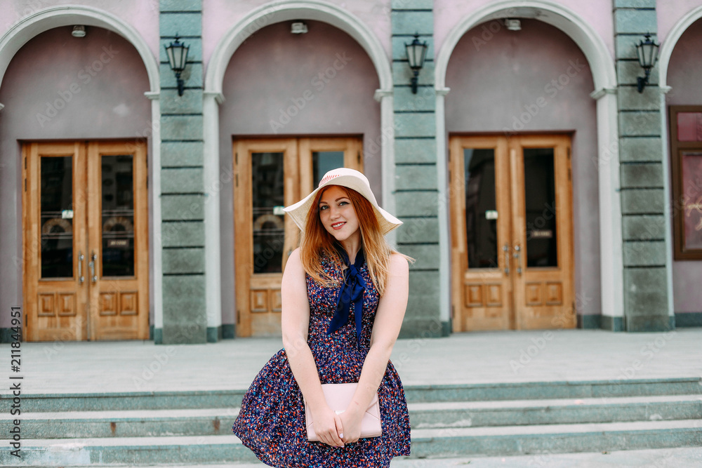 girl with smile light dress hat street