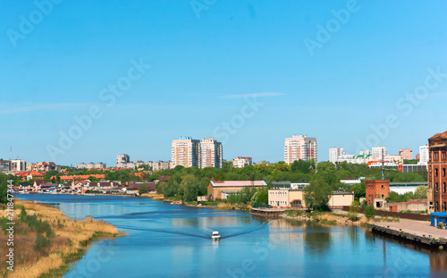 A bridge over the river in the city. A large city across the river.