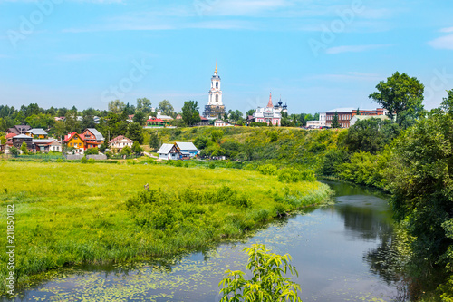Suzdal landscape. Beautiful view of the river Kamenka, green field and old Churches. Golden ring of Russia. 