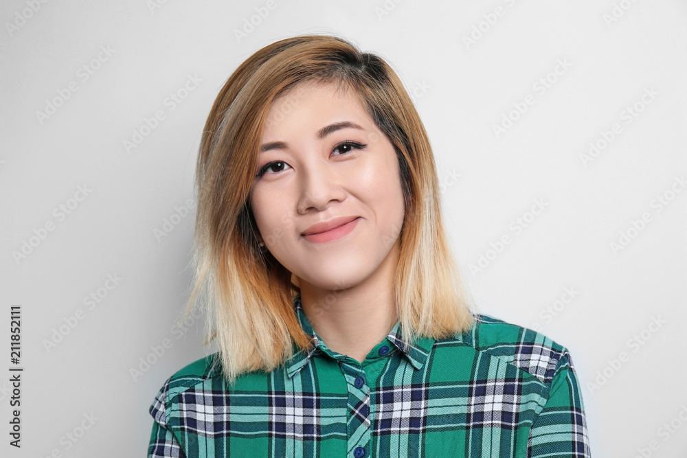 Portrait of beautiful Asian woman on light background Portrait of beautiful Asian woman on light background