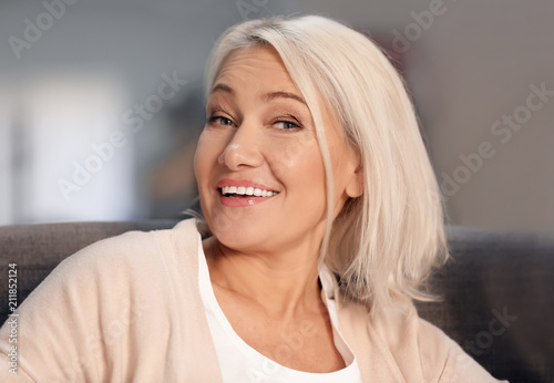 Portrait of smiling mature woman at home