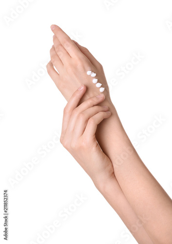 Young woman applying cream onto her hands on white background  closeup