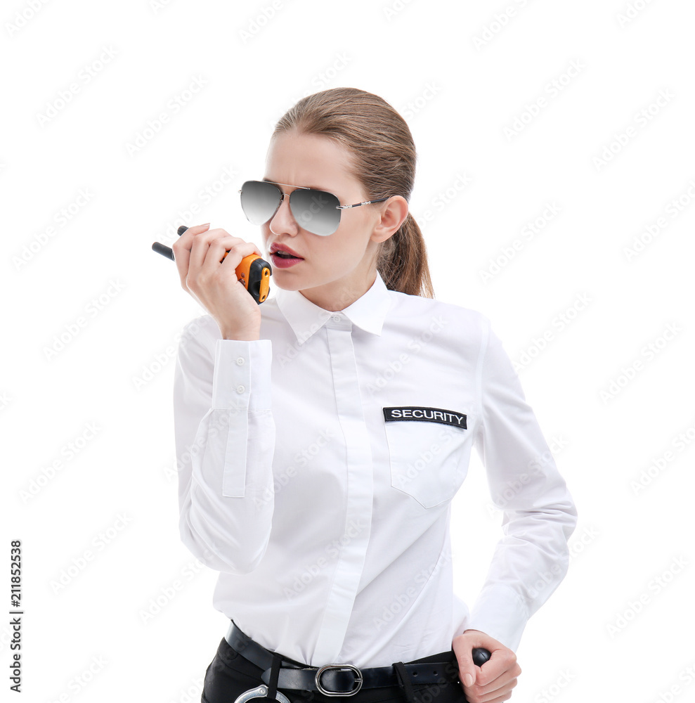 Female security guard using portable radio transmitter on white background Female security guard using portable radio transmitter on white background