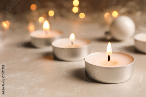 Beautiful burning wax candle on table, closeup