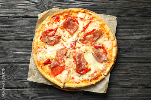 Delicious pizza with meat on wooden background  top view
