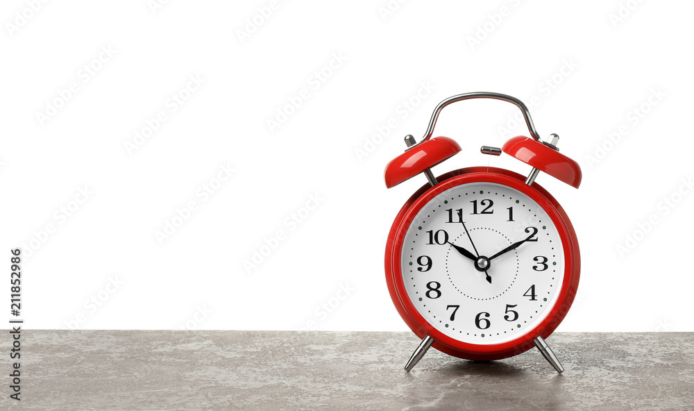 Alarm clock on table against white background. Time concept Alarm clock on table against white background. Time concept