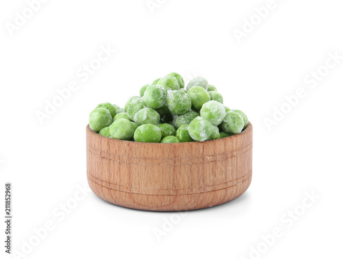 Bowl with frozen peas on white background. Vegetable preservation