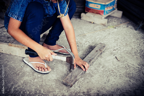 Little girl labor working in commercial building structure, World Day Against Child Labour concept.