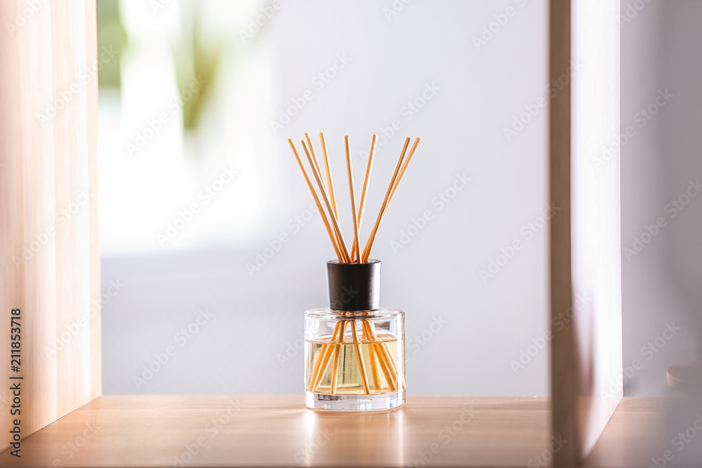 Aromatic reed air freshener on table against blurred background Aromatic reed air freshener on table against blurred background