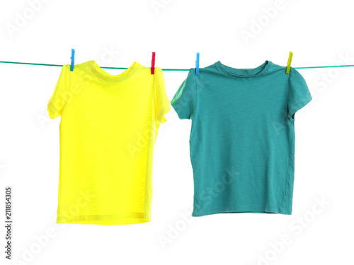 Child clothes on laundry line against white background