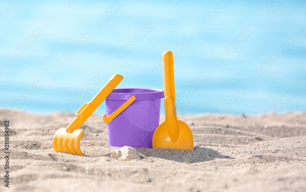 Children toys on sand near sea. Beach object Children toys on sand near sea. Beach object