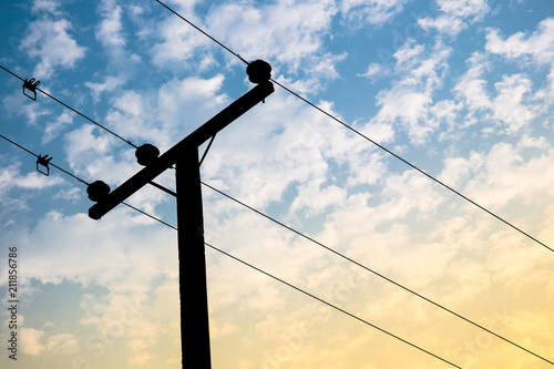 Fotografie High voltage power pole on the blue sky and cloud close up.