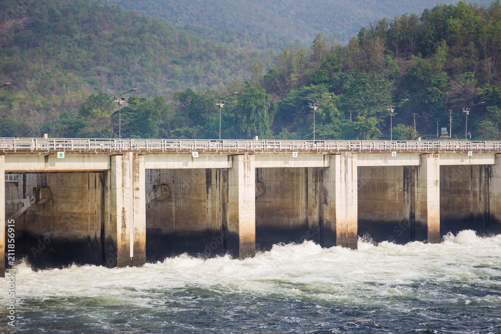 Water flowing from water gate under forced concrete bridge, the power generator from water.