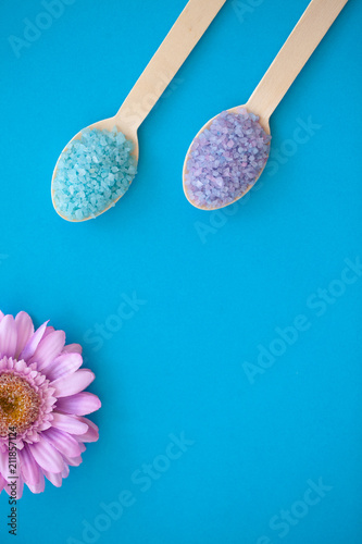 Spa. Organic Sea Salt in Two Wooden Spoons On a Blue Background With a Space For a Text.