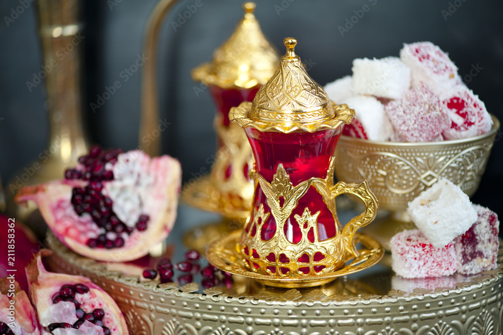 Cup with turkish tasty tea with pomegranate.Oriental tea Cup with turkish tasty tea with pomegranate.Oriental tea