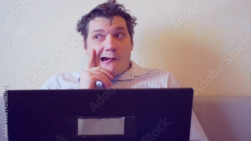 crazy man thinks sitting behind laptop