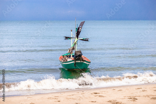 Fishing boats landing at the coast. During the strong sea breeze.