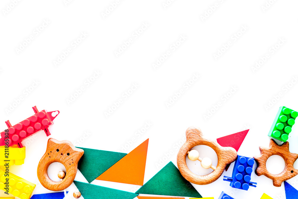 Fototapeta premium Educational toys for children mockup. Plastic blocks and clacks on white background top view copy space