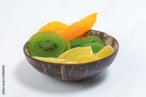 Dry preserved green kiwi pineapple ripe fruit slice colorful sweet in coconut shell bow