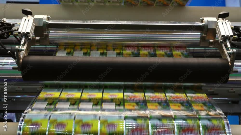 High speed labeling machine in industrial factory. Machine for sticker on product in manufacture. Flexible packaging.