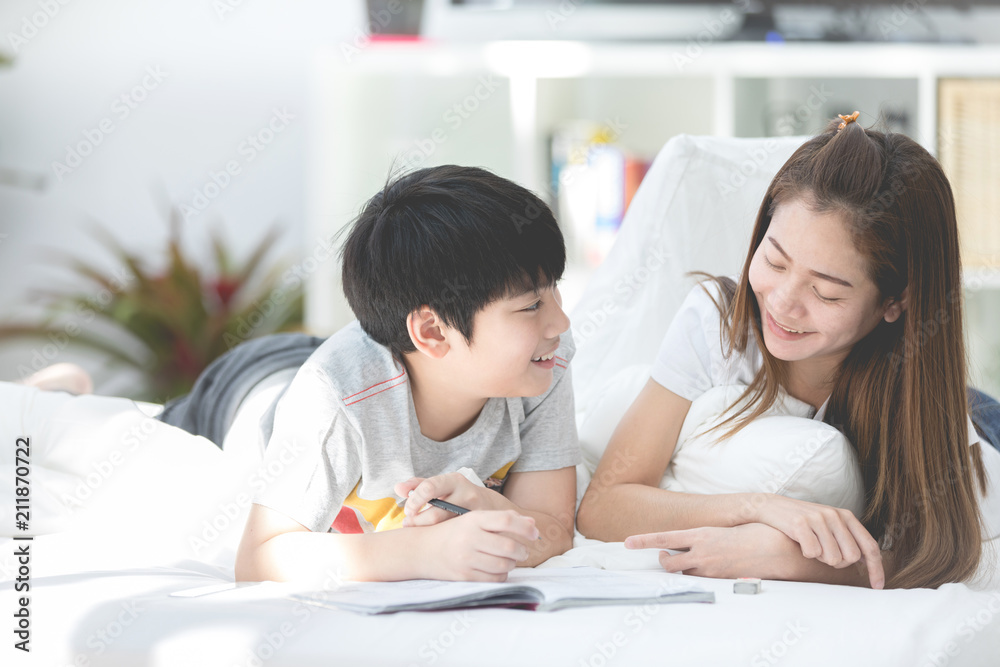 Asian sister and brother relaxing and playing on ther bed. Asian sister and brother relaxing and playing on ther bed.