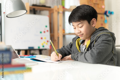 Young asian teenage student doing homework .
