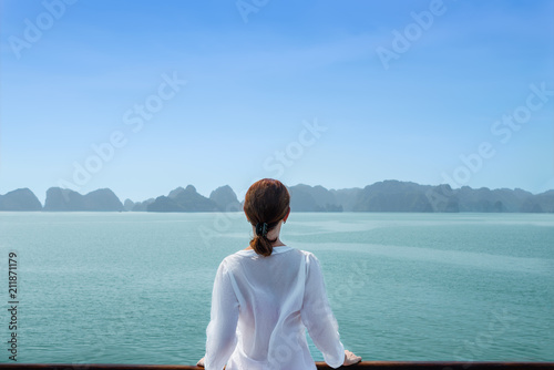 back view woman standing on boat among the islands. photo