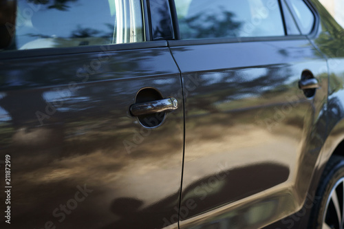 front of the car in the evening light, car door handles