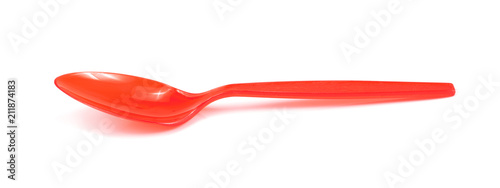 Red plastic spoon isolated on white background photo