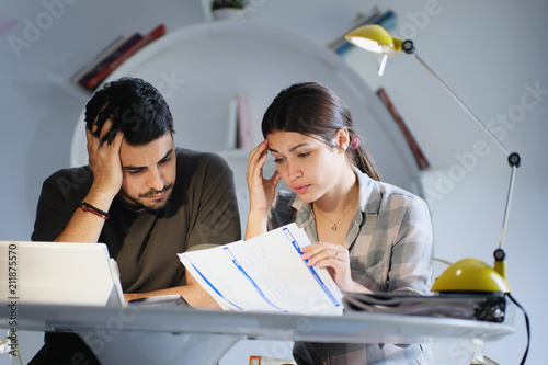 Man and Woman Worried For Taxes And Family Budget photo