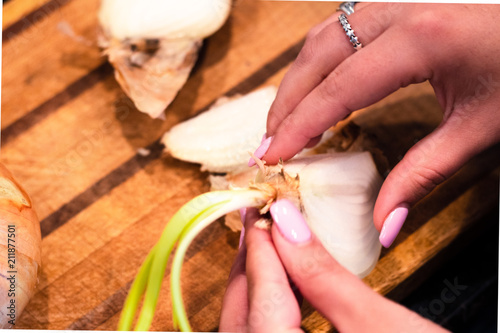A woman handling a fresh onion.
